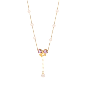 Elegant gold bow necklace with pink heart gems and white pearls on a fine chain