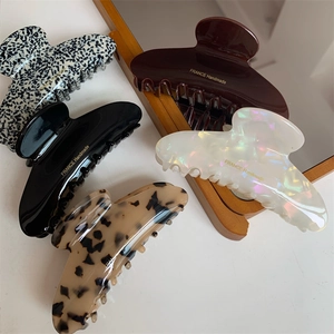 Elegant large curved acetate hair claws in five colors including tortoiseshell and black