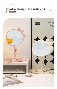 Detail view of cute bow vanity mirror with heart hook and jewelry storage tray