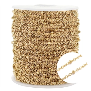 Detail of golden bead chain spool with macro view for DIY jewelry making