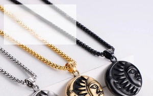 Detailed view of sun and moon pendants in gold, silver, and black stainless steel