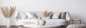Modern living room scene with 3D floral cushion covers on a white sofa and marble table