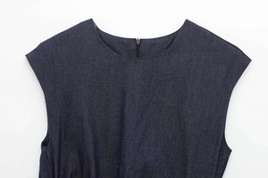 Gros plan détaillé de la robe midi en jean bleu foncé avec col rond et fermeture éclair