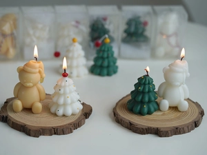 Close-up of lit Christmas tree and bear candles on a wooden base with festive lighting