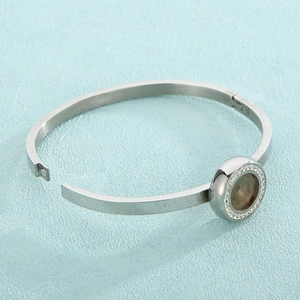 Polished silver stainless steel open bangle with crystal halo DIY setting on blue texture