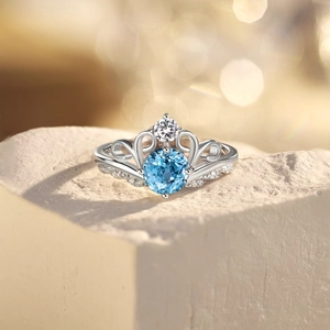Detailed macro view of S925 silver crown ring featuring a brilliant blue round gemstone