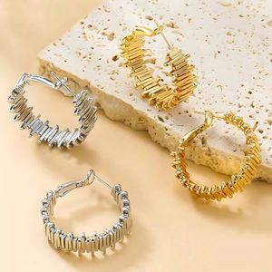 Modern C-shaped twisted metal hoop earrings in polished gold and silver finish