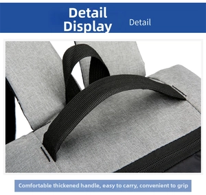 Detail of reinforced thick handle and gray woven texture on a business backpack