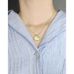 Minimalist gold shell pendant necklace with S925 snake chain on elegant female model