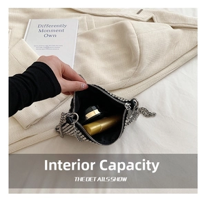 Internal capacity of silver rhinestone square bag showing storage for small cosmetics