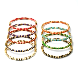 Detail view of 10-piece colorful enamel bead bracelets with gold-plated metal spacers