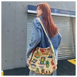 Outdoor shot showing the size and fit of the vintage printed canvas tote bag on a model