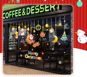 Detailed view of Christmas window decals featuring Santa and reindeer on shop glass