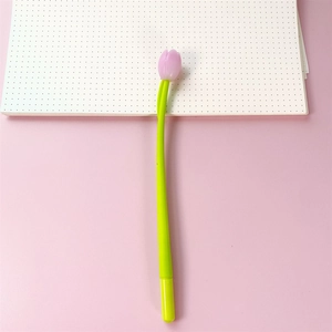 Macro detail of tulip flower pen head resting on a dotted notebook page