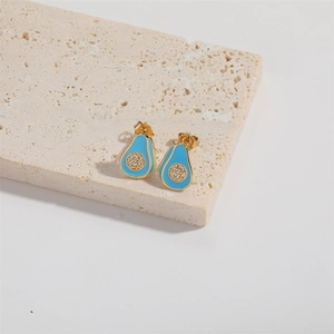 Macro view of gold-plated avocado stud earrings with blue enamel and small white zircons