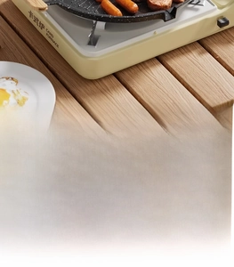 Close-up of non-stick maifan stone grill pan on card stove for outdoor camping BBQ