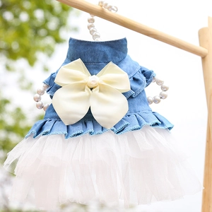 Detail view of pet denim dress with white tulle skirt and pearl bow on a pearl hanger