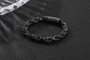Macro detail of men's antique finish steel chain with engraved links and clasp