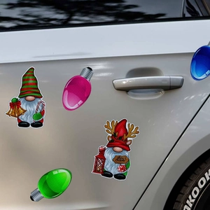 Close-up of Christmas gnome and colorful bulb magnets on a white car door