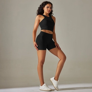Detail of black seamless knitted sports set featuring racerback top and high waist shorts
