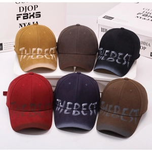Close-up of vintage washed baseball caps in multiple colors with graffiti text print