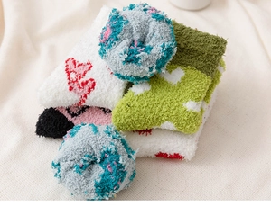 Close-up of soft coral fleece winter socks in multiple colors with heart patterns