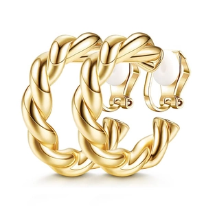 Minimalist gold geometric twist clip-on earrings with white silicone pads on white background