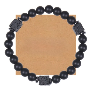 Matte black stone beaded bracelet with volcanic rock on a message gift card for men