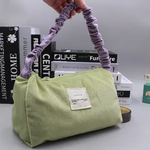 Corduroy tote bag in avocado green and purple with eco-friendly label for women