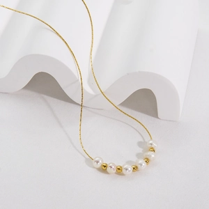 Elegant gold stainless steel necklace featuring alternating white natural pearls and beads