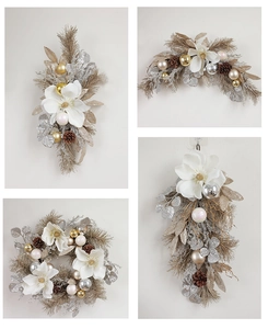 Detail of Christmas wreath with white magnolia, pine cones and silver festive ornaments
