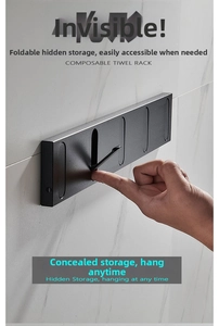Detail of black foldable wall hooks showing the hidden flip design on marble wall surface