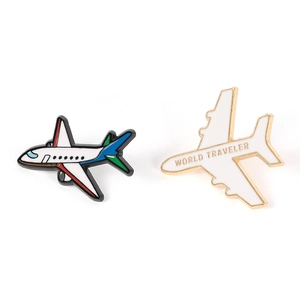 Detail of 3D airplane pins with World Traveler text and colorful enamel finish