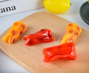 Realistic artificial red and orange mini peppers on a wooden board for kitchen decor