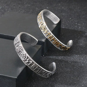 Macro shot of Viking rune engravings and trinity knot details on Norse metal bracelets