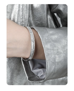 Detailed shot of matte silver S925 sterling silver bangle with sparkling star diamonds