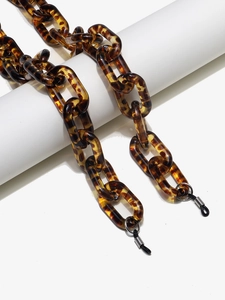 Detail of tortoiseshell acrylic chain link with anti-slip rubber loop for eyewear
