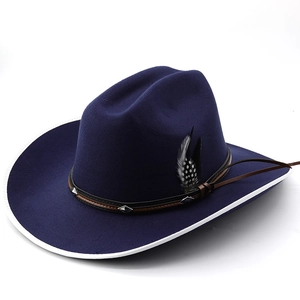 Detail of dark blue cowboy hat with white edge binding, feather and studded leather band