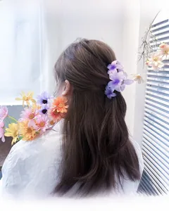 Close-up of a large purple gradient floral hair claw clip worn in a romantic hairstyle
