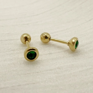Detail of gold titanium steel dumbbell stud earrings with green round-cut zircon stones