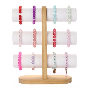 Three-tier bamboo jewelry display stand holding various colorful beaded bracelets on white base