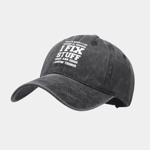 Detailed view of vintage washed cotton baseball cap with embroidered slogan on dark grey