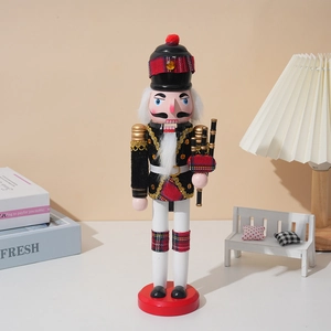 Wooden Nutcracker soldier ornament in Scottish uniform with bagpipes on a red base
