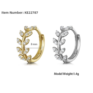 Detailed view of 8mm leaf hoop earrings in gold and silver with cubic zirconia stones