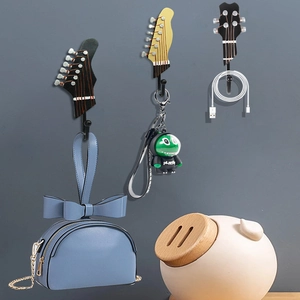 Set of 3 resin guitar head wall hooks for bags and keys in a creative bedroom decor setup