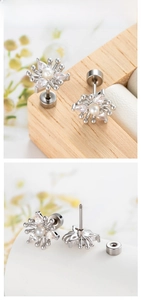 Detail of flower ear cartilage stud with cubic zirconia petals and a center pearl
