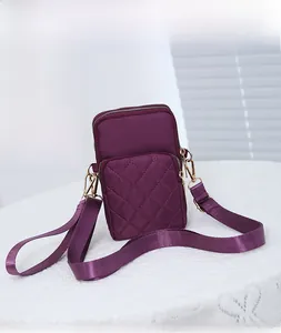 Detail of purple quilted nylon mini crossbody phone bag with gold metal hardware