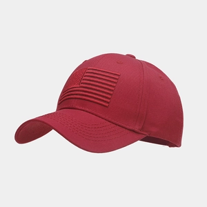 Close-up of red cotton baseball cap with embroidered American flag and reinforced stitching