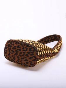 Close-up detail of leopard print suede underarm bag with gold metal rivet studs