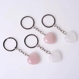 Natural crystal heart-shaped keychains in pink and white with silver metal rings